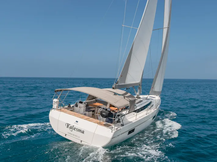 Kalesma Yacht Photos Pics Sailing yacht Bavaria C50 Style 2021 navigating in open sea under clear blue skies.