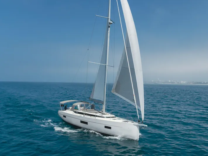Kalesma Yacht Photos Pics 2021 Bavaria C50 Style yacht sailing on open sea under clear blue sky.
