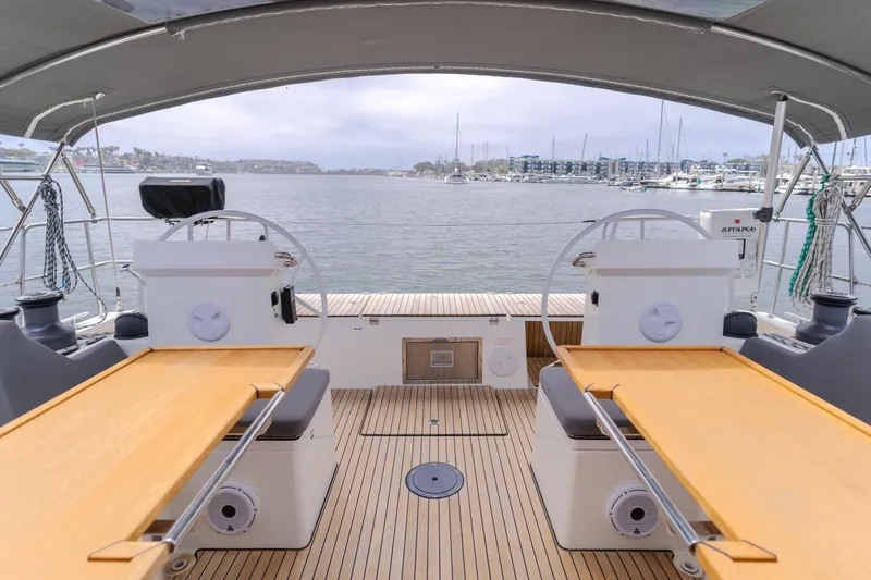 Kalesma Yacht Photos Pics 2021 Bavaria C50 Style yacht deck with dual helm stations, overlooking a marina.