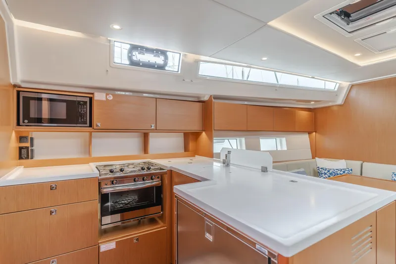 Kalesma Yacht Photos Pics Modern kitchen interior of 2021 Bavaria C50 Style yacht with sleek wood cabinetry.