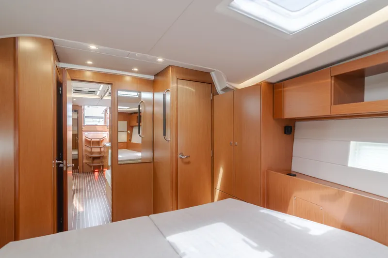 Kalesma Yacht Photos Pics 2021 Bavaria C50 Style yacht interior with wooden cabinetry and modern design.