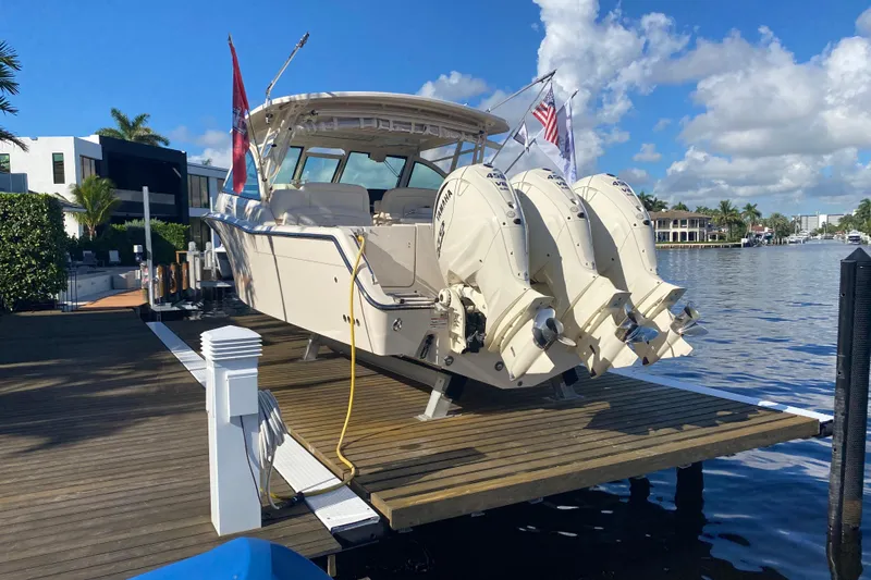  Yacht Photos Pics 2024 Grady-White Freedom 375 boat docked, featuring triple Yamaha outboard engines.
