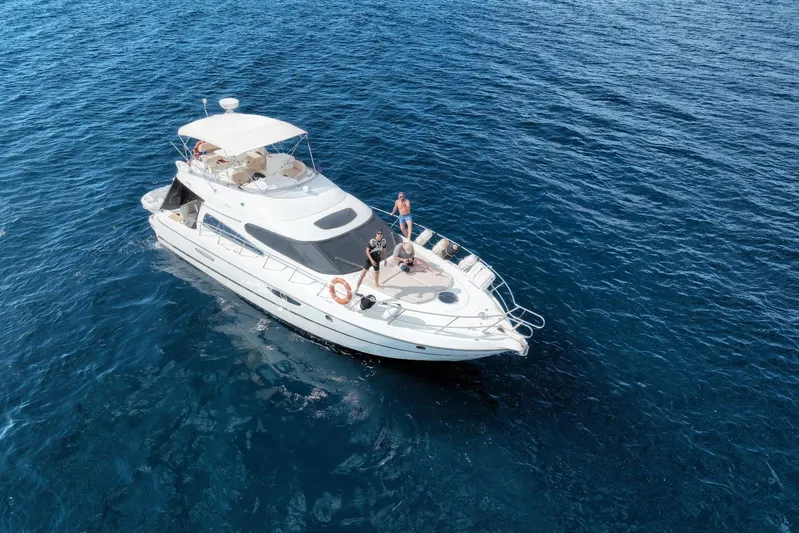 Dawn Yacht Photos Pics 2009 Cranchi Atlantique 50 yacht on open sea with people on deck.