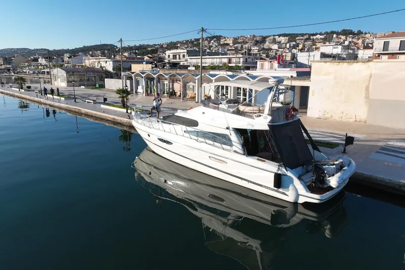 Dawn Yacht Photos Pics 2009 Cranchi Atlantique 50 yacht docked in a serene marina setting.