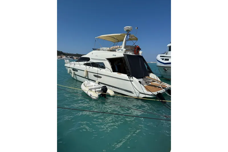 Dawn Yacht Photos Pics 2009 Cranchi Atlantique 50 yacht docked in clear blue water.