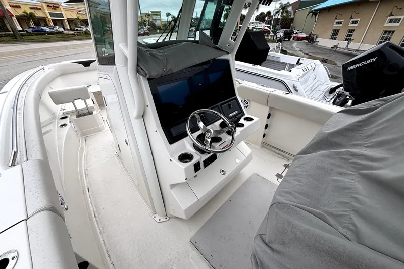  Yacht Photos Pics 2024 Sailfish 272 CC boat interior with steering console and seating area.