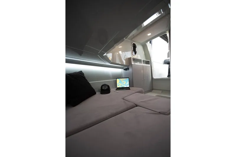  Yacht Photos Pics Interior of 2026 XO Boats DFNDR 9, featuring a cozy cabin with a laptop and cap.