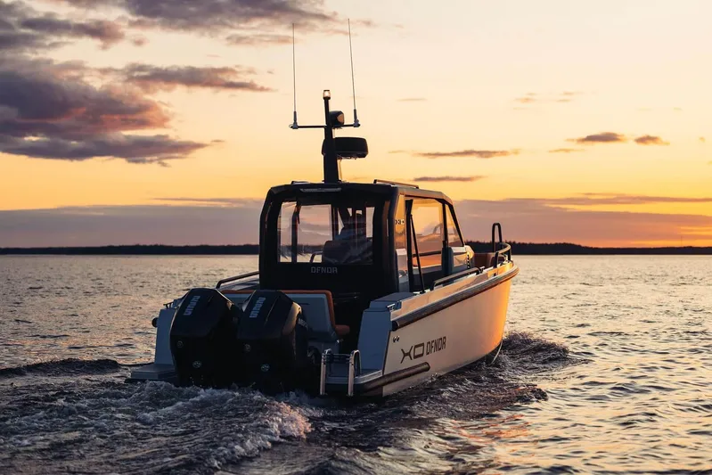  Yacht Photos Pics 2026 XO Boats DFNDR 9 cruising at sunset on open water.
