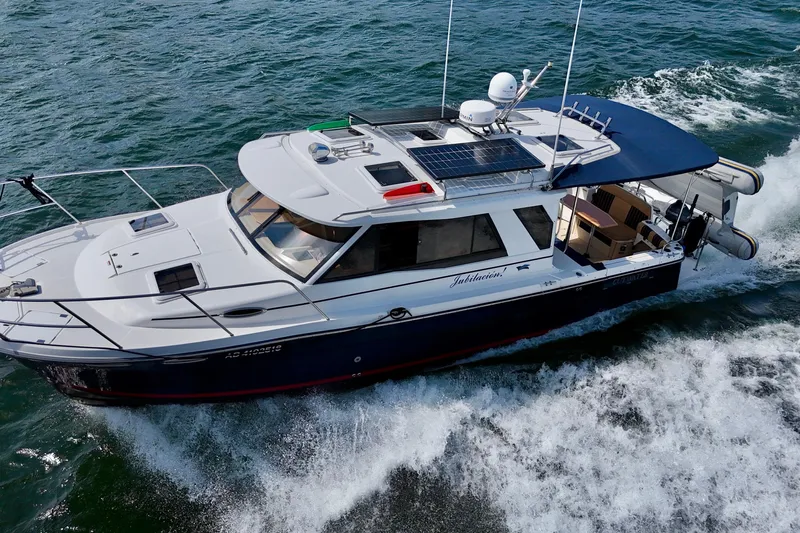  Yacht Photos Pics 2014 Cutwater C30 Sedan NW cruising on open water, featuring solar panels and sleek design.