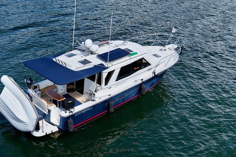  Yacht Photos Pics 2014 Cutwater C30 Sedan NW boat on water, featuring solar panels and a spacious deck.