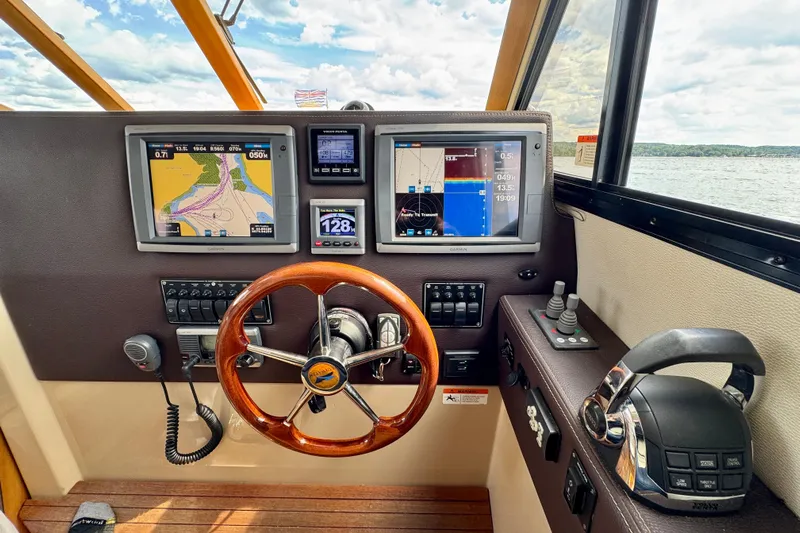  Yacht Photos Pics Helm of 2014 Cutwater C30 Sedan NW with navigation screens and controls.