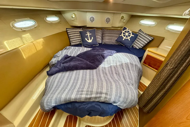 Yacht Photos Pics Cozy cabin interior of 2014 Cutwater C30 Sedan NW with nautical-themed bedding.