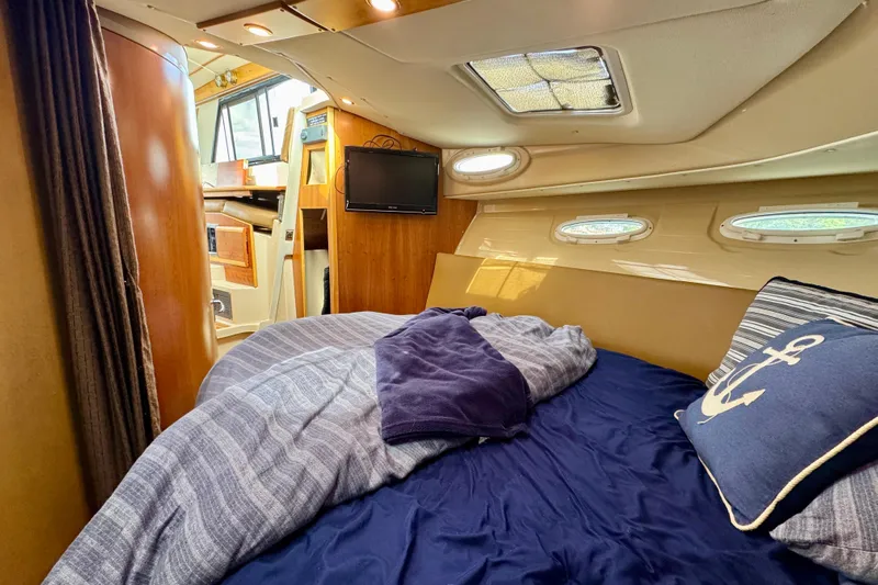  Yacht Photos Pics Cozy cabin interior of 2014 Cutwater C30 Sedan NW with bed and nautical decor.