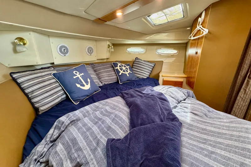  Yacht Photos Pics Cozy cabin interior of 2014 Cutwater C30 Sedan NW with nautical-themed bedding.