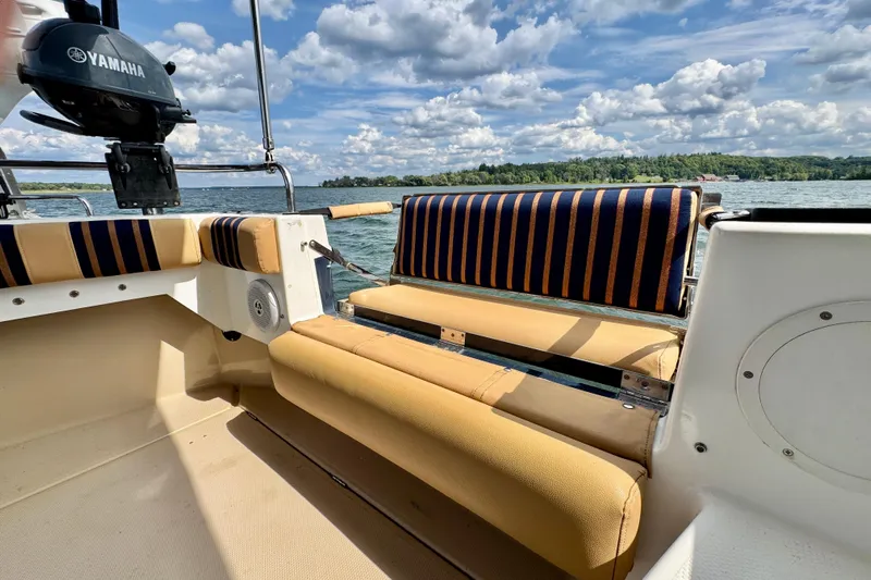  Yacht Photos Pics 2014 Cutwater C30 Sedan NW boat interior with striped seating, Yamaha motor, and scenic lake view.