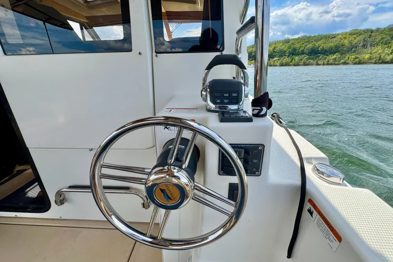  Yacht Photos Pics Steering wheel and controls of 2014 Cutwater C30 Sedan NW boat on a lake.