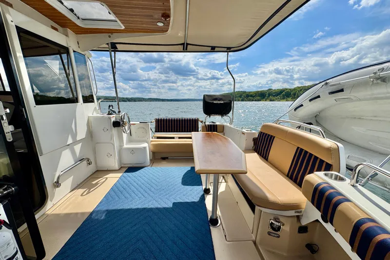  Yacht Photos Pics 2014 Cutwater C30 Sedan NW boat interior with seating, table, and scenic lake view.