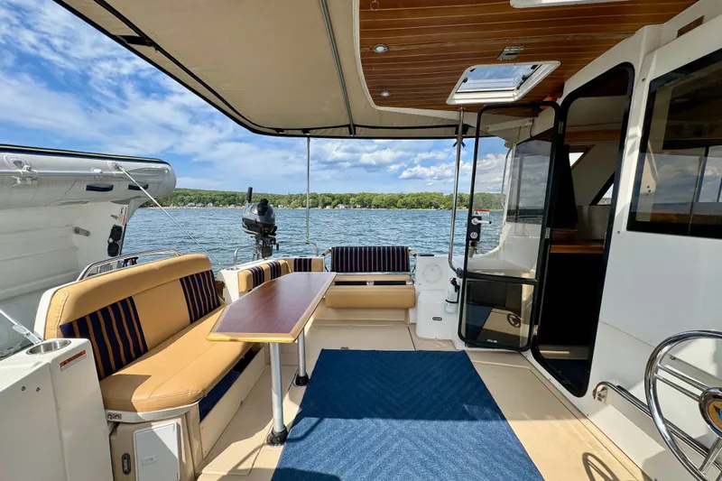  Yacht Photos Pics 2014 Cutwater C30 Sedan NW boat interior with seating, table, and lake view.
