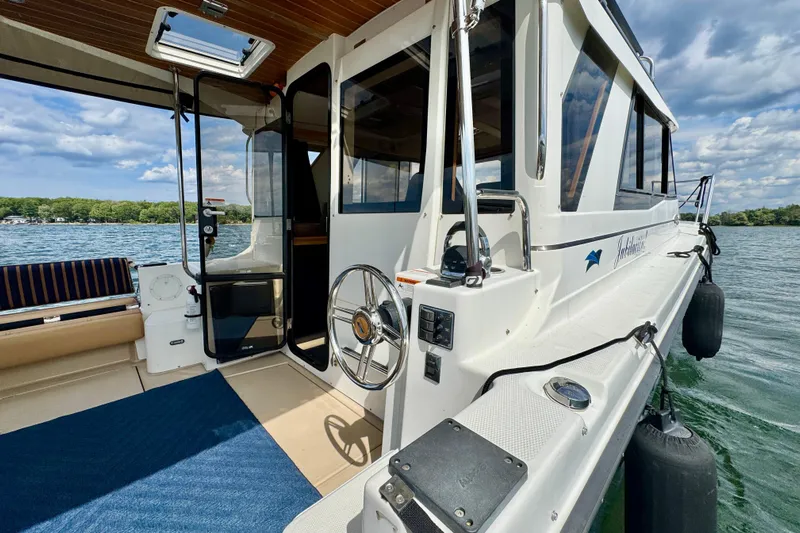  Yacht Photos Pics 2014 Cutwater C30 Sedan NW boat on water, showcasing deck and interior entrance.