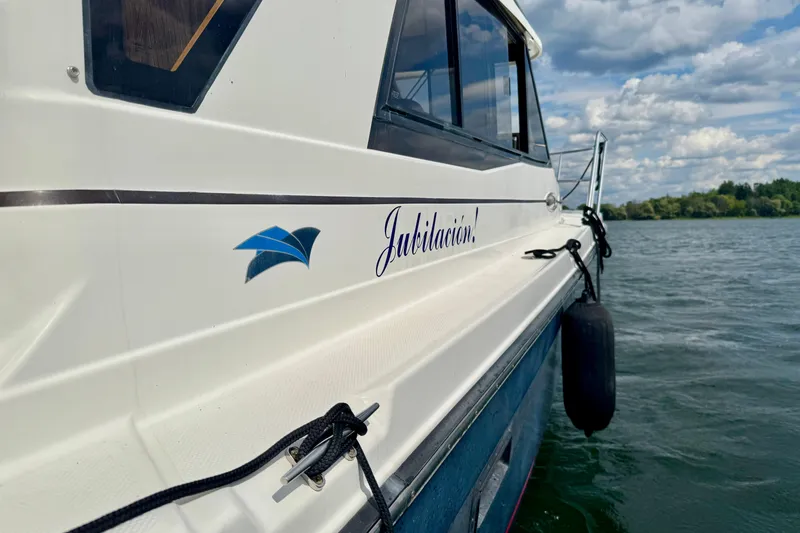  Yacht Photos Pics 2014 Cutwater C30 Sedan NW boat on water, side view with "Jubilación!" text.