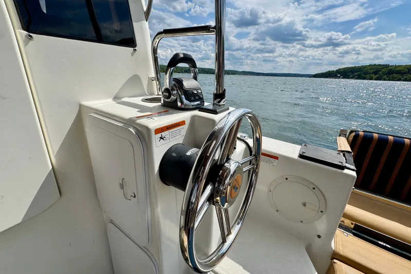  Yacht Photos Pics Steering wheel of 2014 Cutwater C30 Sedan NW boat on a sunny lake.