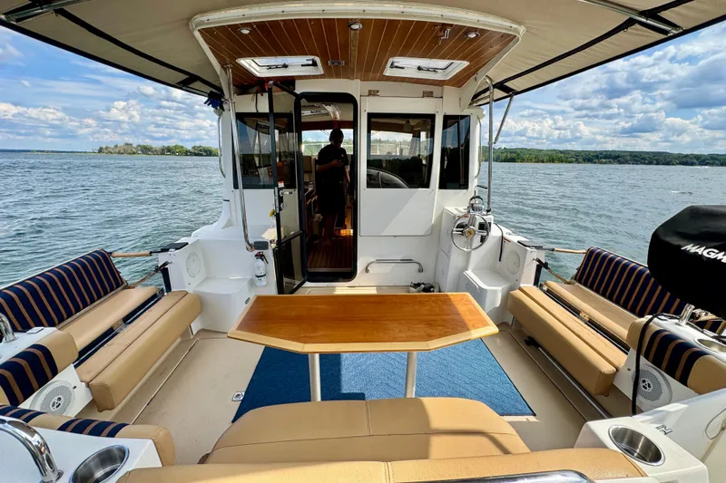  Yacht Photos Pics 2014 Cutwater C30 Sedan NW boat interior with seating, table, and scenic water view.