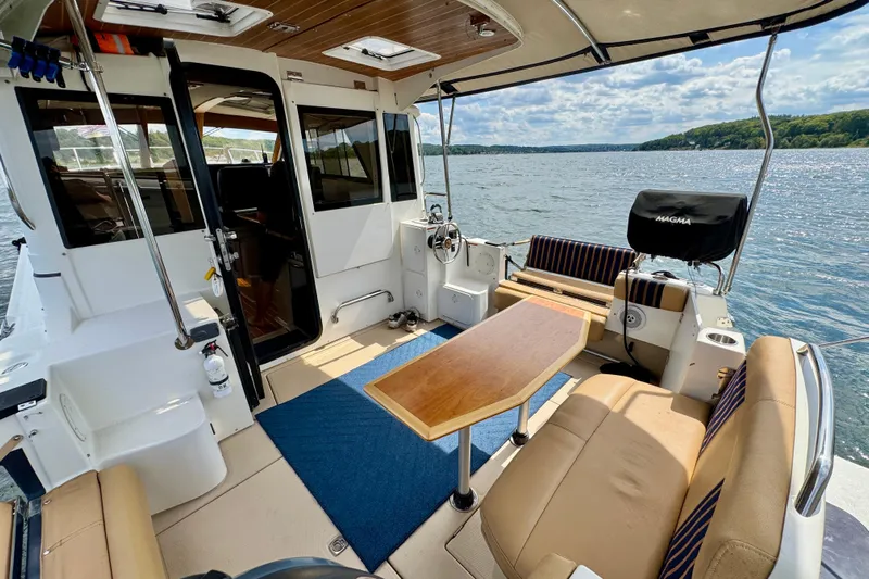  Yacht Photos Pics 2014 Cutwater C30 Sedan NW boat interior with seating, table, and lake view.