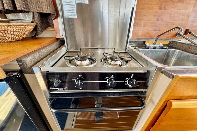  Yacht Photos Pics 2014 Cutwater C30 Sedan NW kitchen with stainless steel stove and sink.