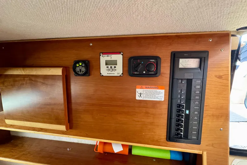  Yacht Photos Pics 2014 Cutwater C30 Sedan NW control panel with various switches and meters on wooden interior.