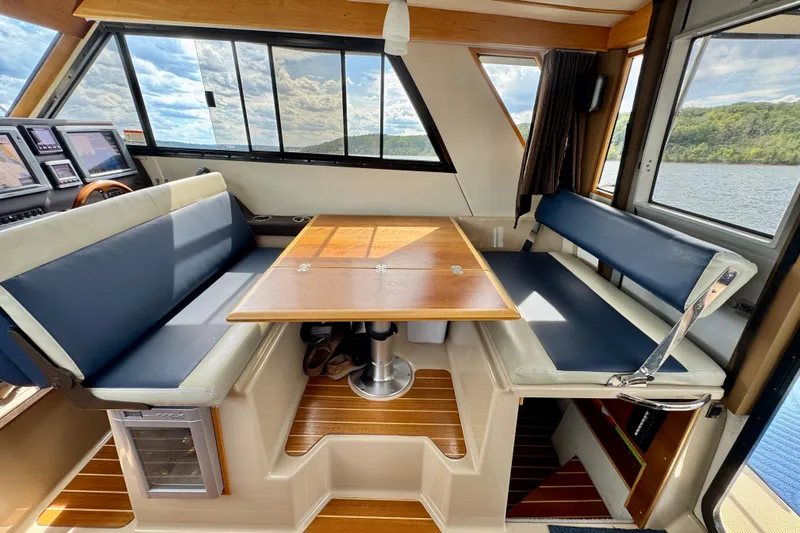  Yacht Photos Pics Interior of 2014 Cutwater C30 Sedan NW boat with seating and table, overlooking water.