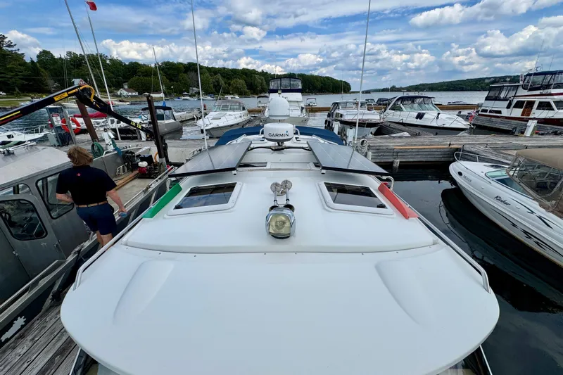  Yacht Photos Pics 2014 Cutwater C30 Sedan NW docked at marina with other boats under cloudy sky.