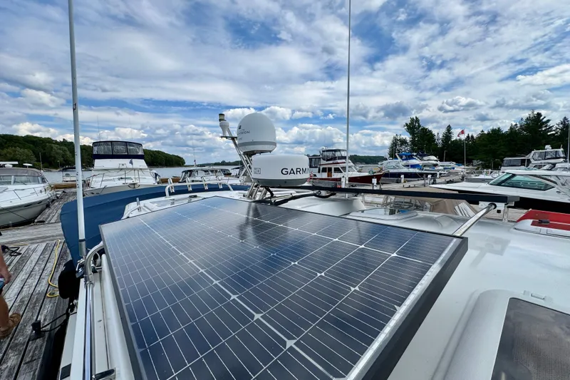  Yacht Photos Pics 2014 Cutwater C30 Sedan NW with solar panels docked at a marina under a cloudy sky.