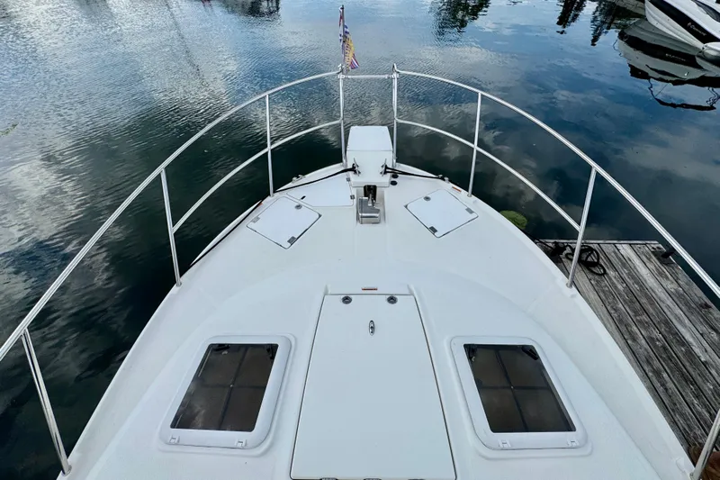  Yacht Photos Pics 2014 Cutwater C30 Sedan NW boat deck with railing, docked on calm water.