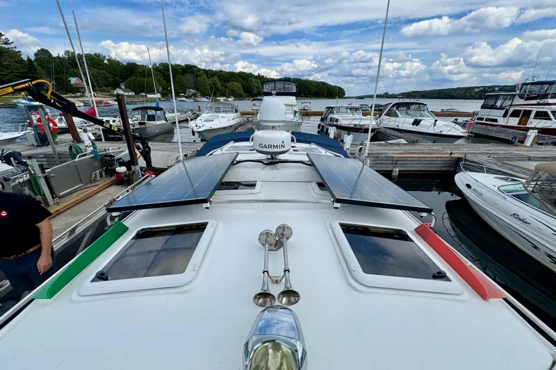  Yacht Photos Pics 2014 Cutwater C30 Sedan NW with solar panels docked at a marina.