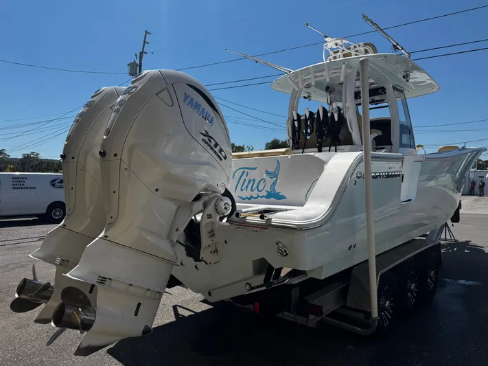  Yacht Photos Pics 2024 Sportsman Open 322 Center Console boat with twin Yamaha engines on a trailer.