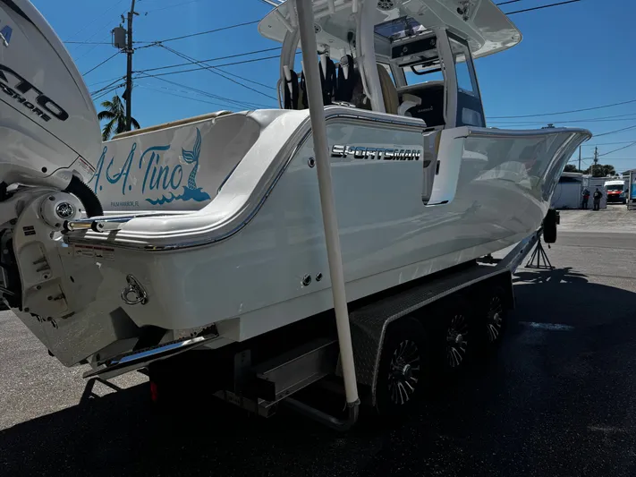  Yacht Photos Pics 2024 Sportsman Open 322 Center Console boat on trailer, featuring sleek design and powerful engine.
