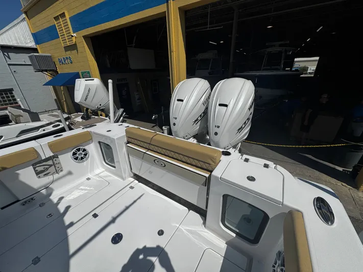  Yacht Photos Pics 2024 Sportsman Open 322 Center Console boat with twin Yamaha V8 engines at a marina.