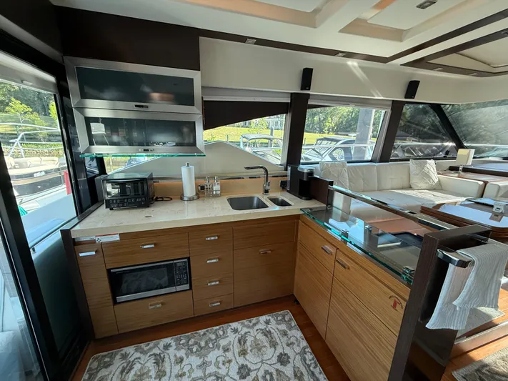 Swift Wing Yacht Photos Pics Luxurious kitchen interior of 2016 Tiara Yachts 50 Coupe with modern appliances and sleek design.