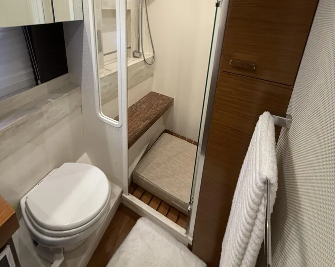 Swift Wing Yacht Photos Pics Bathroom interior of 2016 Tiara Yachts 50 Coupe, featuring shower and toilet.