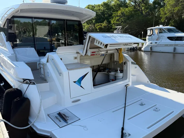 Swift Wing Yacht Photos Pics 2016 Tiara Yachts 50 Coupe docked, featuring open storage compartment and sleek design.