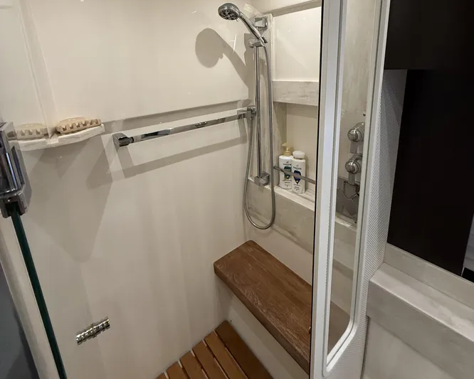 Swift Wing Yacht Photos Pics Shower area in 2016 Tiara Yachts 50 Coupe with wooden bench and modern fixtures.