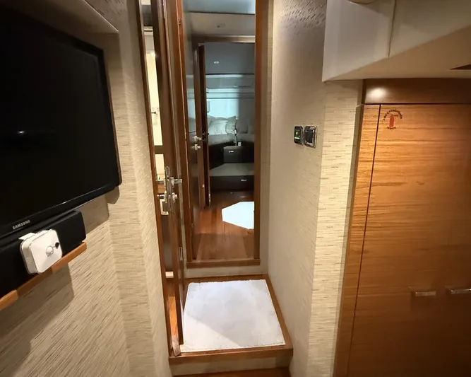 Swift Wing Yacht Photos Pics Interior hallway of 2016 Tiara Yachts 50 Coupe, featuring wood finishes and modern design.