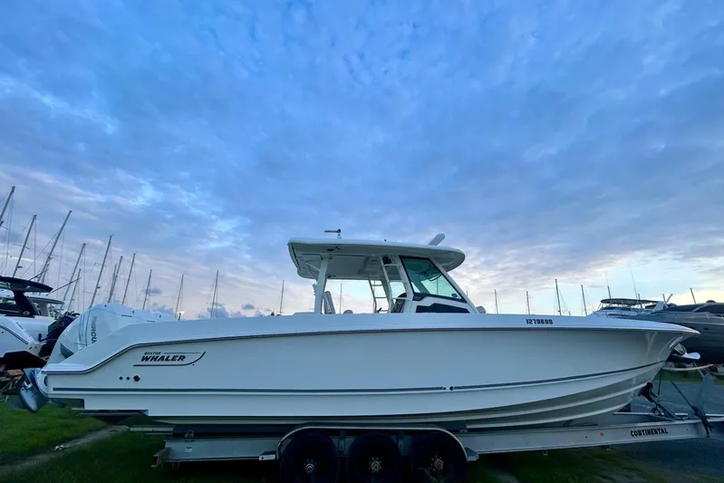  Yacht Photos Pics 2017 Boston Whaler 380 Outrage boat on trailer under a cloudy sky.