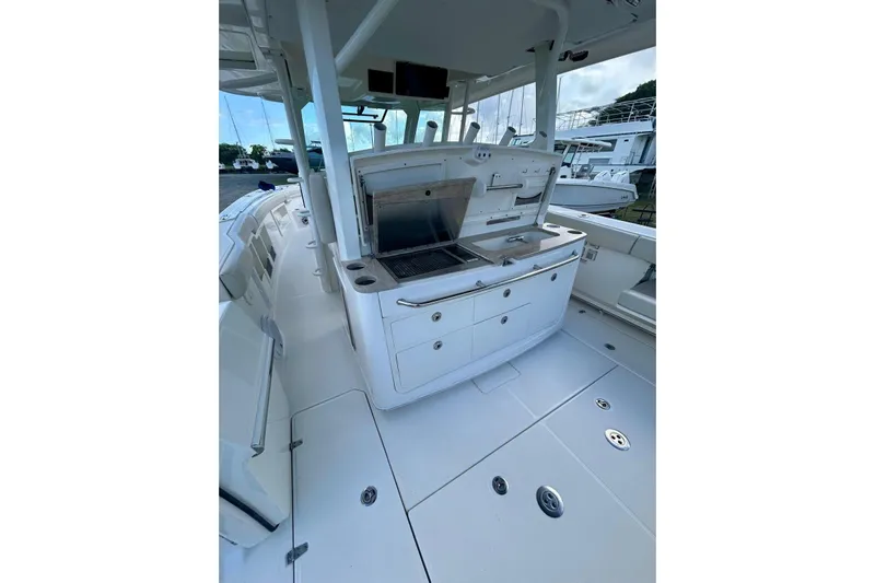  Yacht Photos Pics 2017 Boston Whaler 380 Outrage boat interior with sleek white deck and built-in amenities.