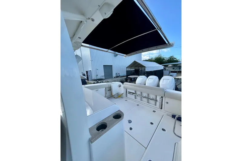  Yacht Photos Pics 2017 Boston Whaler 380 Outrage boat deck with seating and canopy.