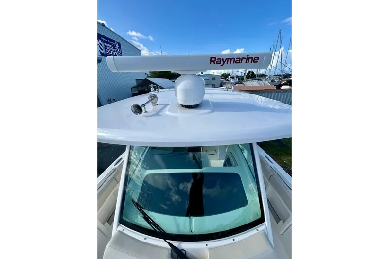 Yacht Photos Pics 2017 Boston Whaler 380 Outrage with Raymarine radar, docked under clear blue sky.
