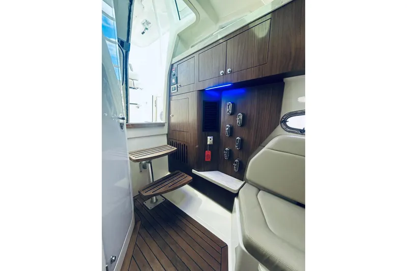  Yacht Photos Pics Interior of 2017 Boston Whaler 380 Outrage, featuring wood accents and modern controls.