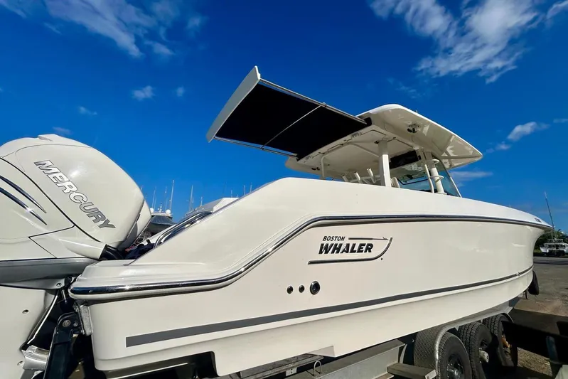  Yacht Photos Pics 2017 Boston Whaler 380 Outrage boat with Mercury engines under a clear blue sky.