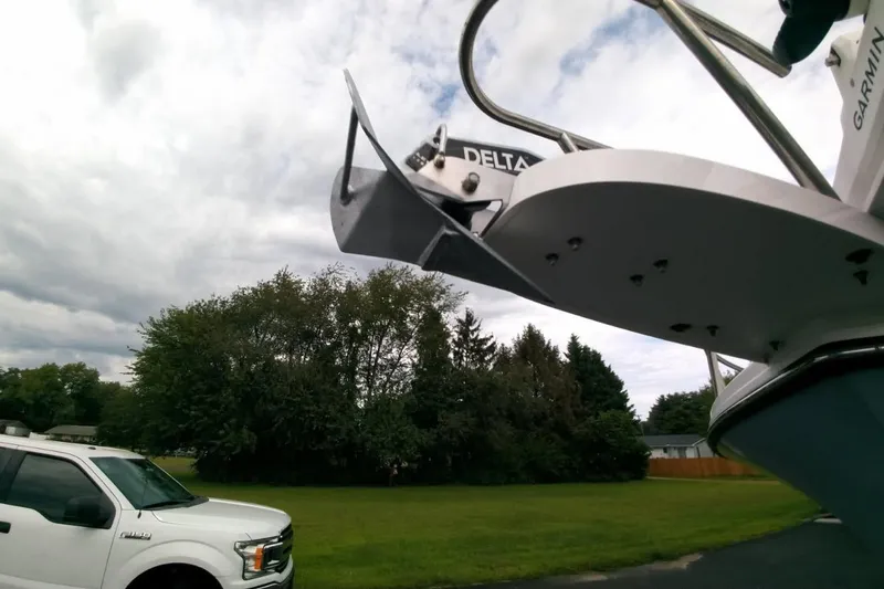  Yacht Photos Pics 2024 Parker 2820 XLD Sport Cabin boat with anchor, parked near a white truck.