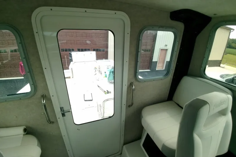  Yacht Photos Pics 2024 Parker 2820 XLD Sport Cabin interior with white seating and windows.
